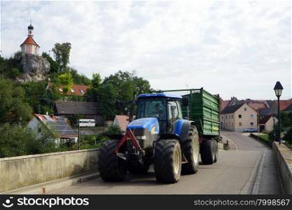 WORNITZSTEIN, GERMANY - 1 SEPTEMBER 2015 Tractor on the stone bridge near chapel on the rock