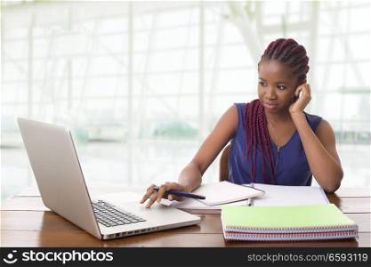 worried beautiful business woman working with a laptop on a desk, at the office