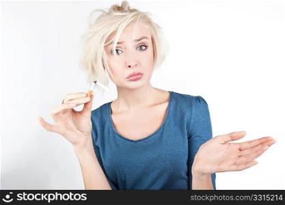 Worried blond lady holding a broken cigarette