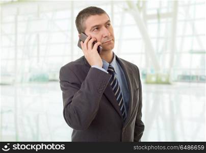 worried business man on the phone, at the office. calling