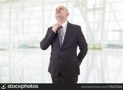 worried businessman in a suit looking up, at the office