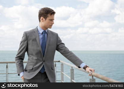 Worried businessman standing by terrace railings