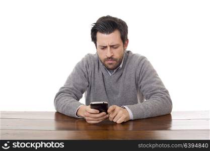 worried casual man with a phone, on a desk, isolated