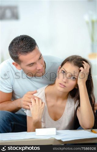 worried couple after fight sitting on sofa