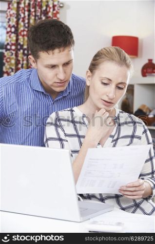 Worried Couple Discussing Domestic Finances At Home
