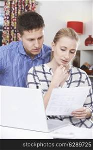 Worried Couple Discussing Domestic Finances At Home