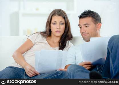 Worried couple looking at paperwork