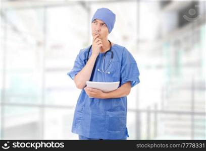 worried doctor looking to his notes, at the hospital