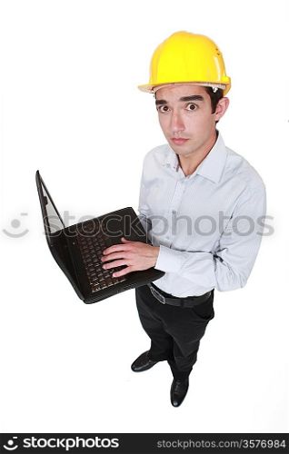 Worried engineer holding a laptop