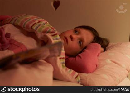 Worried Girl Lying In Bed Awake At Night
