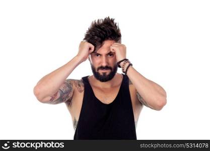 Worried handsome guy with tattoos on his arms isolated on a white background