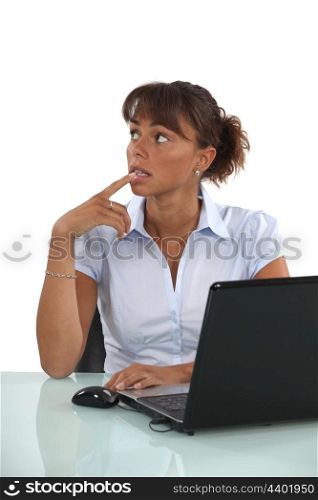Worried looking office worker with a laptop