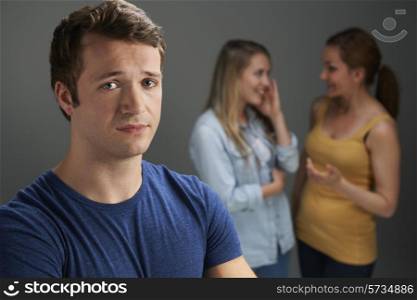 Worried Man Being Talked About By Women