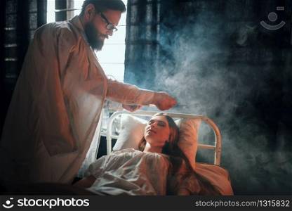 Worried man standing against ill loved woman in hospital bed. Illness of female patient in clinic room, health recovery and treatment. Man standing against ill woman in hospital bed