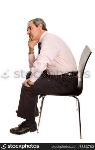 worried mature businessman on a chair, isolated on white