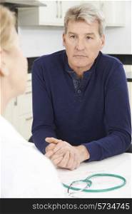 Worried Mature Woman Meeting With Doctor In Surgery