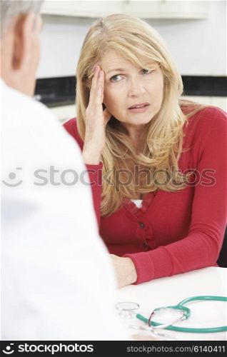 Worried Mature Woman Meeting With Doctor In Surgery