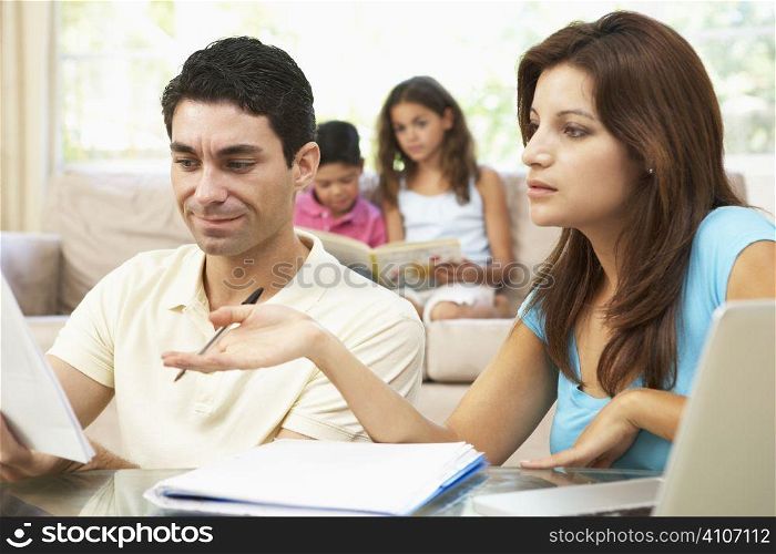 Worried Parents Using Laptop At Home