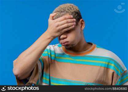 Worried sad man, no, he forgot. Disappointed guy feeling sorrow, regret, drama, failure, problems on blue background. High quality photo. Worried sad man, no, he forgot. Disappointed guy feeling sorrow, regret, drama, failure, problems on blue background.