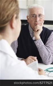 Worried Senior Man Meeting With Doctor In Surgery