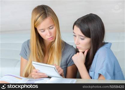 worried student trying to memorize a lesson with a friend