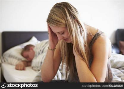 Worried Teenage Girl In Bedroom With Boyfriend