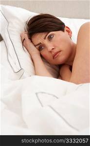 Worried Woman Laying Awake In Bed