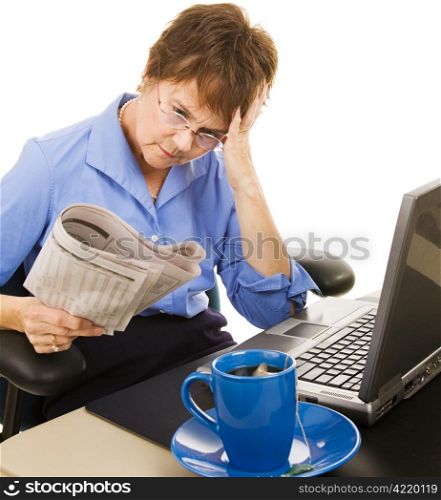 Worried woman reading the stock section of the newspaper. White background.