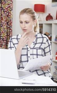 Worried Woman Using Laptop And Revbiewing Domestic Finances