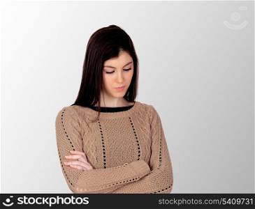 Worry teenager isolated on a grey background