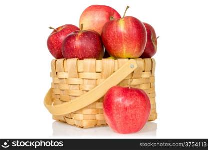 Woven basket full of red apples. Isolated on white background