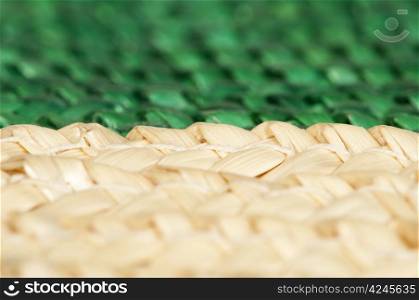 Woven straw natural background. Green and beige colors