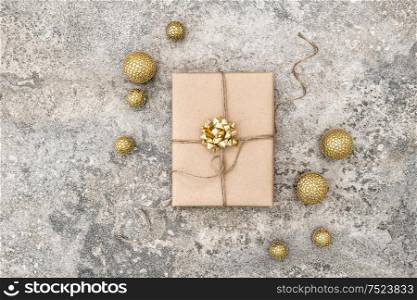 Wrapped gift and christmas decoration on concrete stone background