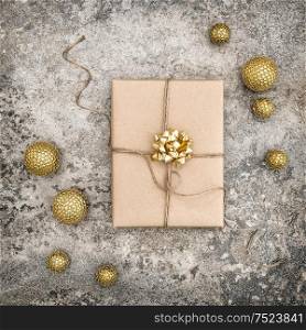 Wrapped gift and christmas decoration on concrete stone background. Perfect for social media square picture