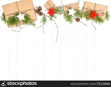 Wrapped gifts border with christmas decoration and evergreen branches on bright background