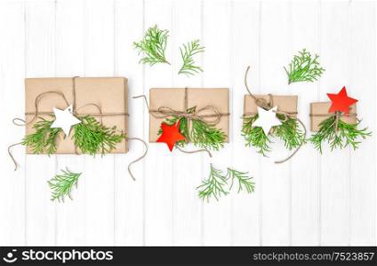 Wrapped gifts with christmas decoration and evergreen branches on bright background