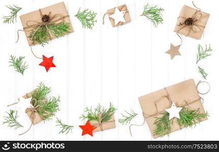 Wrapped gifts with christmas decoration on bright wooden background. Flat lay