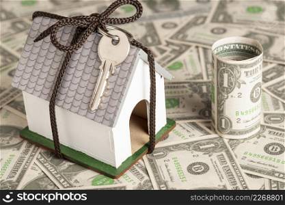 wrapped house with keys money background