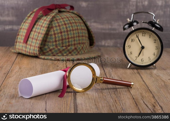 Wrapped paper sheets and magnifying glass on Old Wooden table.