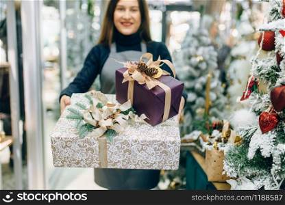 Wrapping service seller with festive gift boxes, professional handmade decoration. Presents packing. Wrapping service seller with festive gift boxes