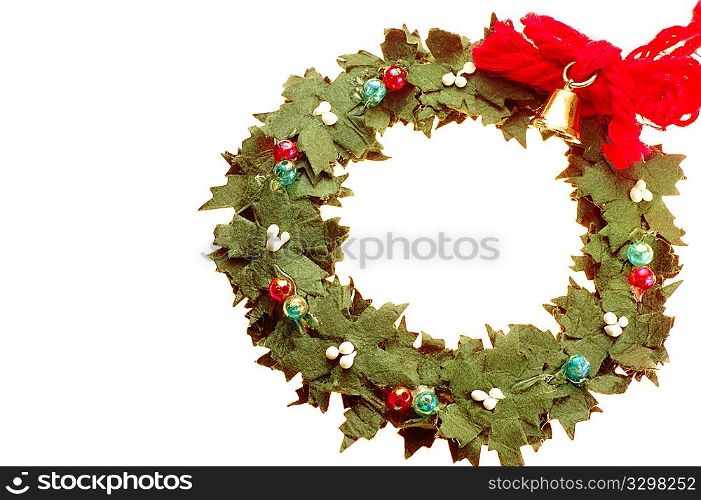 Wreath decorated with a small golden bell isolated on white background