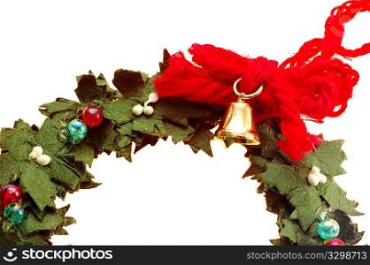 Wreath decorated with a small golden bell isolated on white background