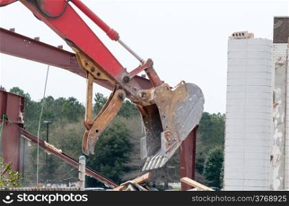 wreck excavator at work demolishing a building wall