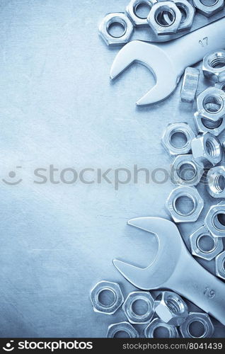 wrench and nut tool on metal background texture
