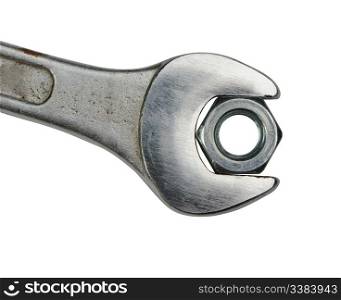 Wrench with a nut. It is isolated on a white background