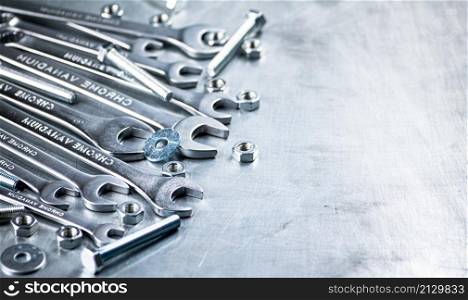 Wrench with nuts and bolts. On a gray background. High quality photo. Wrench with nuts and bolts.