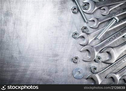 Wrench with nuts and bolts. On a gray background. High quality photo. Wrench with nuts and bolts.