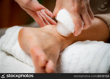Wrist Injury Ice Massage. Hands of a therapist placing ice directly onto a painful wrist to relieve pain, reduce inflammation and swelling and promote healing.. Wrist injury Ice Massage