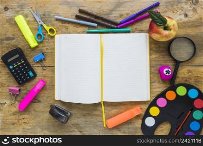 writing implements apple laid circle with notebook middle