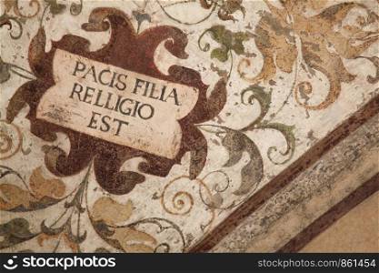 Writing on ceiling painting shows text about religion and peace